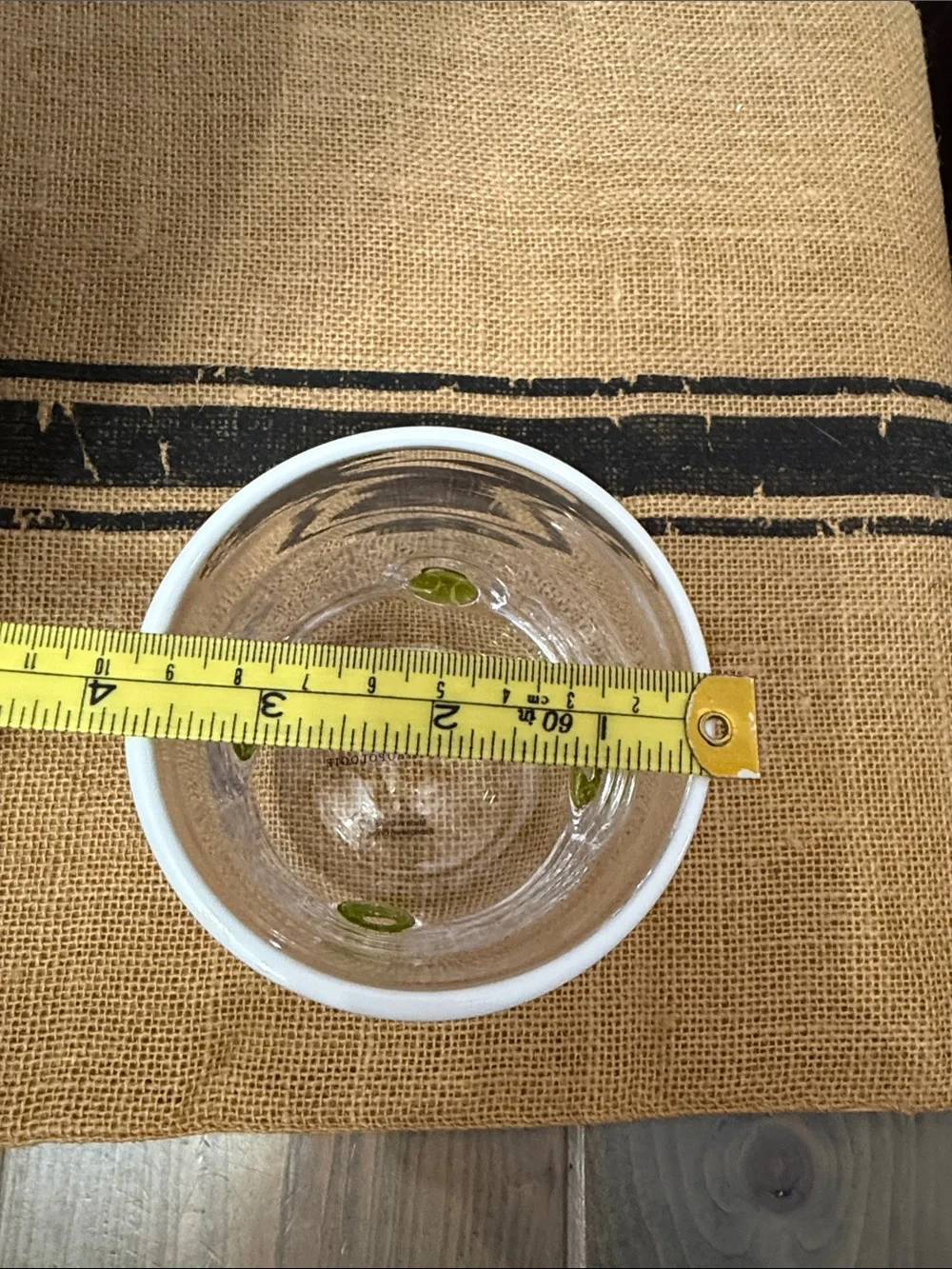 Anthropologie Clear drinking glass with yellow/green tennis ball accents.